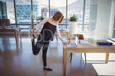 Attentive executive using laptop while exercising