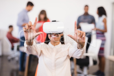 Businesswoman gesturing while using vr glasses