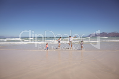 Distant view of family enjoying at beach