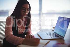 Young businesswoman working on desk at office