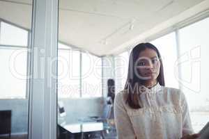 Confident businesswoman standing in office