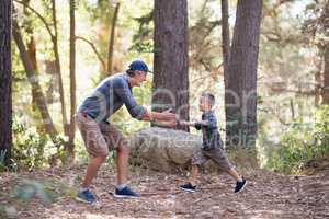 Playful father and son hiking in forest