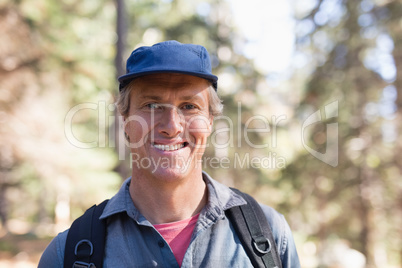 Portrait of happy hiker wearing blue cap