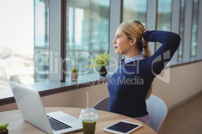 Executive stretching her hands while working