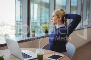 Executive stretching her hands while working