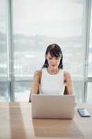 Attentive executive using laptop at desk