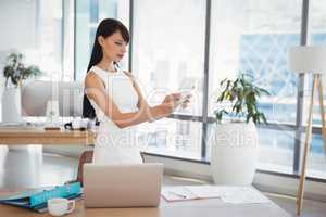 Attentive executive using digital tablet at desk