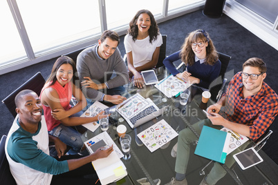 High angle portrait of business people sitting at desk