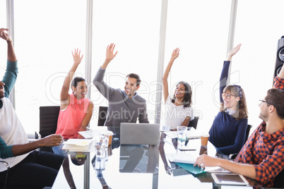 Happy business people with arms raised