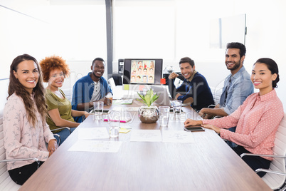 Portrait of business people sitting at desk