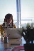Entrepreneur working on laptop at office desk