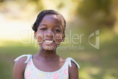 Smiling girl standing in forest