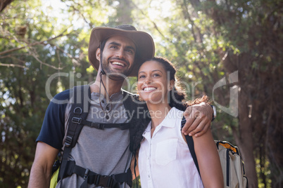 Happy couple standing in forest