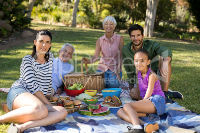 Portrait of happy family having picnic in the park