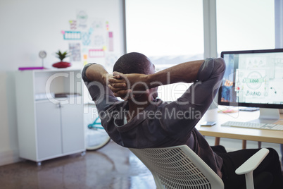 Businessman resting on chair in creative office