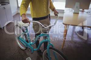 Low section of businesswoman with bicycle office