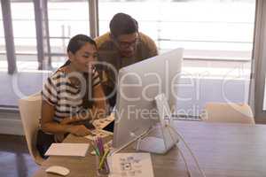 Businesswoman working with colleague in office
