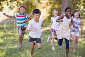 Happy friends running at campsite