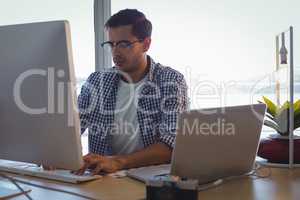 Male graphic designer using computer in creative office