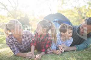 Family lying outside the tent on a sunny day