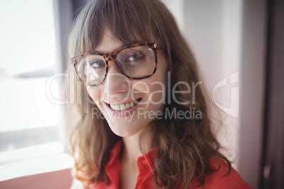 Smiling female interior designer standing in office