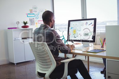 Businessman using computer in creative office