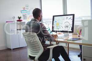 Businessman using computer in creative office