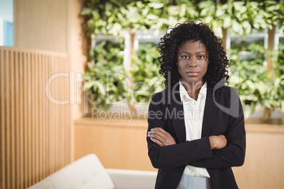 Portrait of executive standing with arms crossed