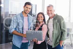 Portrait of smiling business people with laptop