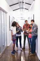 Business people using technologies in corridor