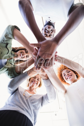 Directly below portrait of business people stacking hands