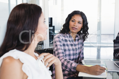 Businesswoman discussing with colleague at office