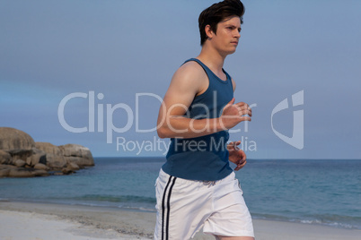 Man jogging on beach on a sunny day