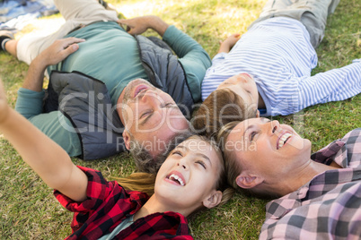 Happy family lying on the grass