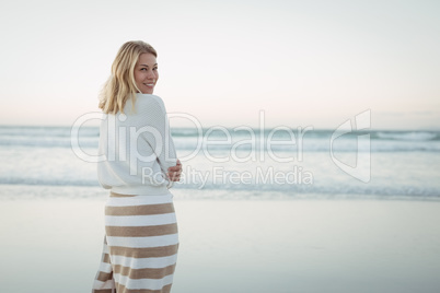 Portrait of woman standing at beach