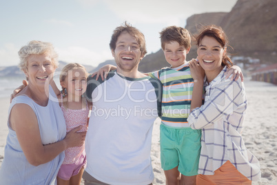 Portrait of multi-generated family embracing at beach