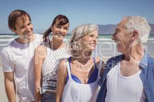 Happy family standing in row at beach