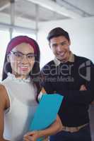 Portrait of smiling young business colleagues at office