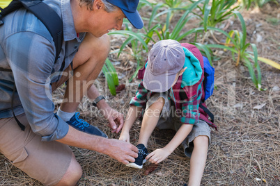 High angle view of man tying shoelace of son