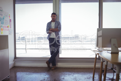 Portrait of male designer standing in office