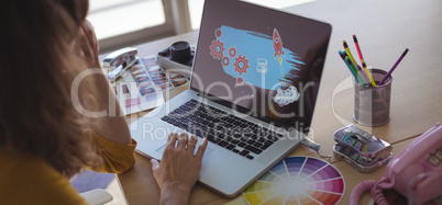 graphic designer working on laptop in office