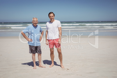 Portrait of man with father standing at beach