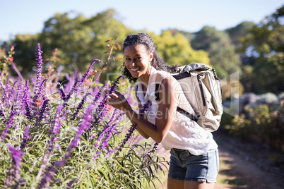 Portrait of happy woman standing by lavender field