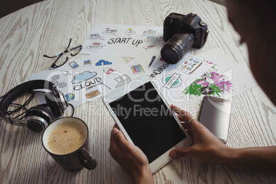 Businesswoman using digital tablet at creative office desk