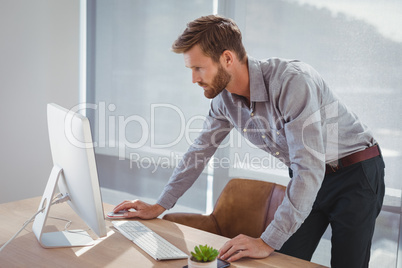 Attentive executive working on personal computer at desk