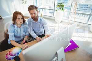 Attentive executives working over personal computer at desk