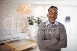 Portrait of smiling executive standing with arms crossed