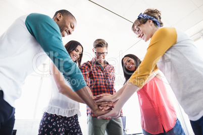 Low angle view of business people stacking hands