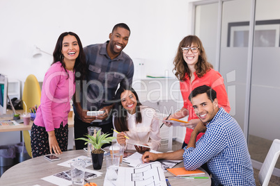 Smiling business people at desk