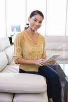 Portrait of smiling businesswoman using tablet computer in office